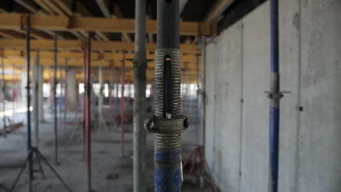 Adjustable metal prop at construction site Stock Footage 311462033