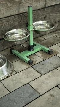 Adjustable metal stand with two stainless steel pet bowls. Stock Photos