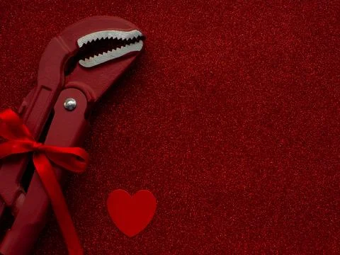 Adjustable pipe wrench as a gift on red background Stock Photos