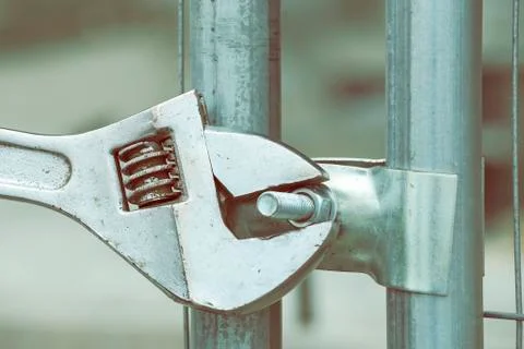 Adjustable spanner gripping bolt nut Stock Photos