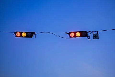 Adjustable traffic lights against the dark evening sky 写真素材