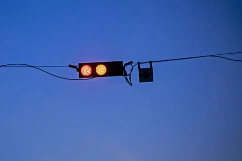 Adjustable traffic lights against the dark evening sky 写真素材