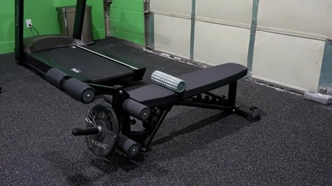 Adjustable weight bench with foam roller in physiotherapy gym Stock Footage 330584078