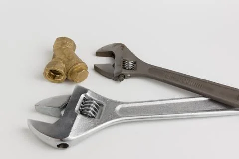 Adjustable wrench and a pipe Stock Photos