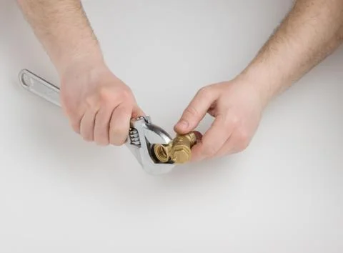 Adjustable wrench and a pipe Stock Photos