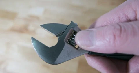 Adjustable wrench or spanner being opened, close up. Holding spanner in hand. Stock Footage 119239188