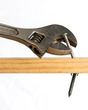 Adjustable wrench removing a nail Stock Photos