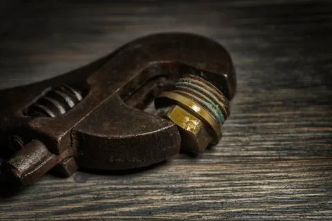 Adjustable wrench on a rustic wood background Stock Photos