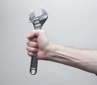 Adjustable wrench in worker hand Stock Photos