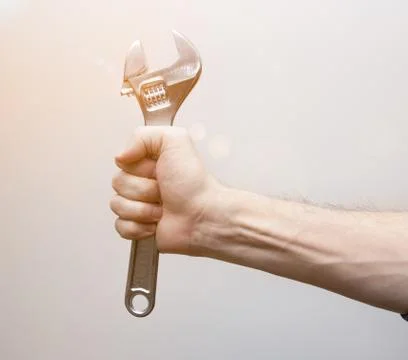 Adjustable wrench in worker hand Stock Photos