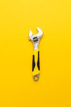 Adjustable wrench with yellow handle Stock Photos