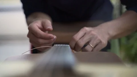 Adjusting acoustic guitar string chord Stock Footage 102825804