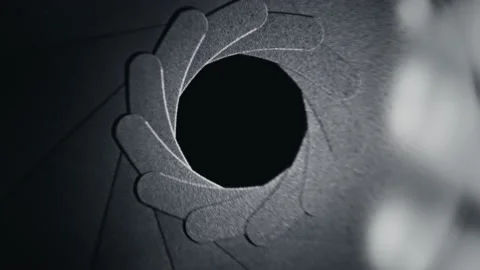 Adjusting aperture on camera lens. Close up view. Iris blades open and close Stock Footage 168591743