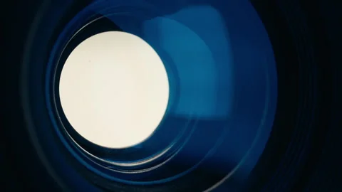 Adjusting aperture on camera lens. Close up view. Iris blades open close slowly Stock Footage 252817318