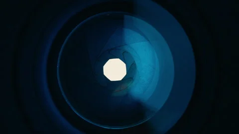 Adjusting aperture on camera lens. Close up view. Iris blades open close slowly Stock Footage 252817466
