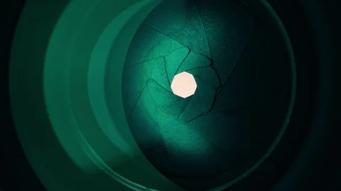 Adjusting aperture on camera lens. Close up view. Iris blades open close slowly Stock Footage 252817625