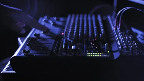 Adjusting Audio Mixer Knobs in Blue Light Video stock 319422431