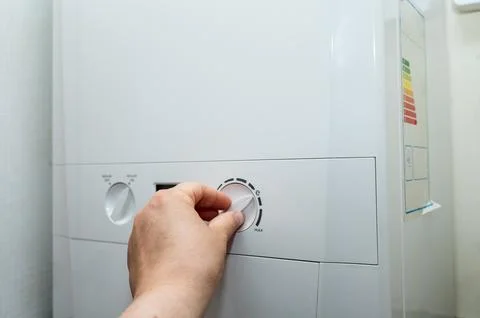 Adjusting boiler control knob. Stock Photos