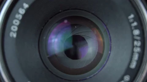 Adjusting camera lens aperture. camera aperture opens slowly and then closes. Stock Footage 136488049