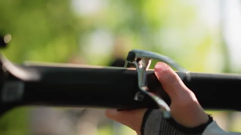 Adjusting capo on guitar strings. Closeup of finger attaching clamp to guitar Stock Footage 327987110