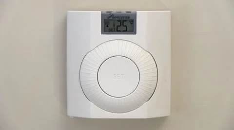 Adjusting a central heating thermostat Stock-Footage 12352400