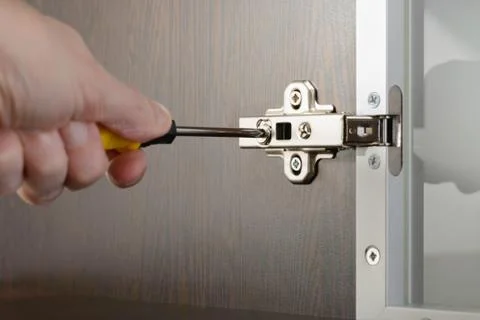 Adjusting a Concealed Hinge Stockfoto's