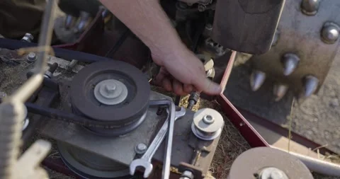 Adjusting the engine belt of the mulching machine, part 1 Stock Footage 308189481