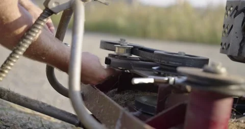 Adjusting the engine belt of the mulching machine, part 2 Stock Footage 308189516