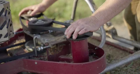 Adjusting the engine belt of the mulching machine, part 3 Stock Footage 309637528