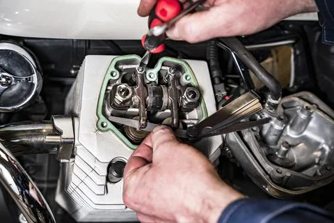 Adjusting engine valves of motorcycle at the workshop 스톡 사진