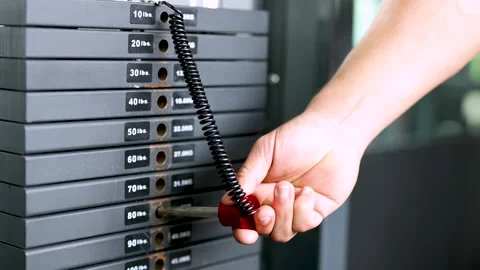 Adjusting Gym Equipment Weight Stack in Bangkok Gym Stockbeeldmateriaal 310592063