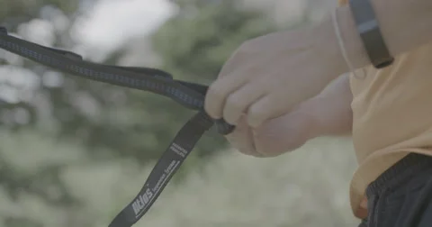 Adjusting hammock straps Stock Footage 65144340