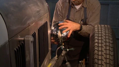 Adjusting a headlight on a classic hot rod Stock Footage 74110779