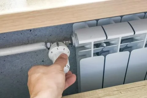 Adjusting the heating temperature with regulator Stock Photos