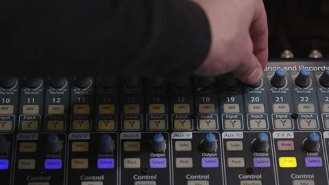 Adjusting knob on an audio recording studio audio mixing board Stock Footage 89498381