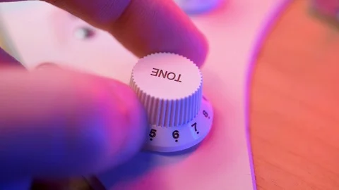 Adjusting the knob of tone setting on a electric guitar 스톡 동영상 119580820
