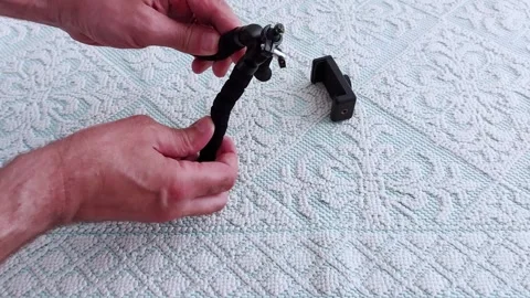 Adjusting a Mini Tripod: Quick Setup for Stable Shots Anywhere Video stock 311695207