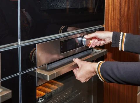 Adjusting oven temperature for baking Stock Photos