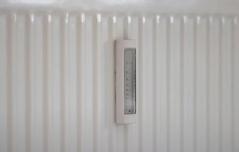 Adjusting the radiator temperature using a thermostat in an apartment Stock Photos