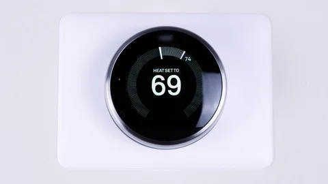 Adjusting the room temperature using a smart thermostat. Stock Footage 99955712