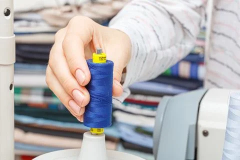 Adjusting the sewing machine, threads in female hands Stock Photos