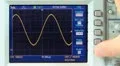 Adjusting sine wave on oscilloscope HD Footage