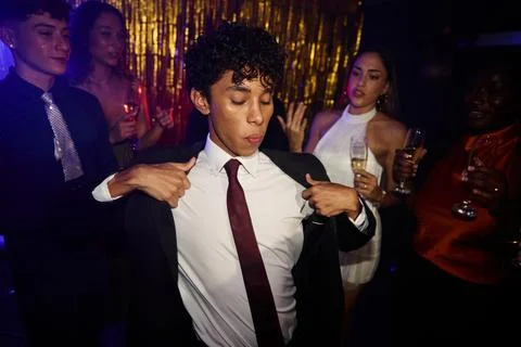 Adjusting a suit jacket during a dressed up night out 스톡 사진