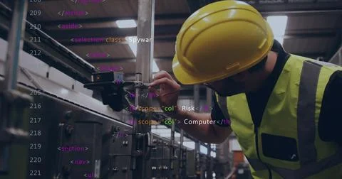 Adjusting tech tightening clamp on rail at plant, in hardhat and vest, code Foto stock