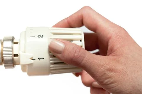 Adjusting a temperature thermostat Stock Photos