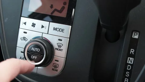 Adjusting temperatures in an automobile Stock Footage 261696906