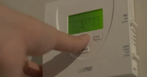 Adjusting Thermostat and Heating Stock-Footage 118027459