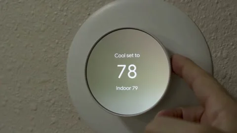 Adjusting Thermostat for Energy Saving Stock Footage 307585645
