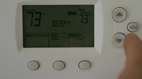 Adjusting a Thermostat Stock-Footage 540531