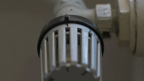 Adjusting thermostat on the radiator Stock Footage 88211114